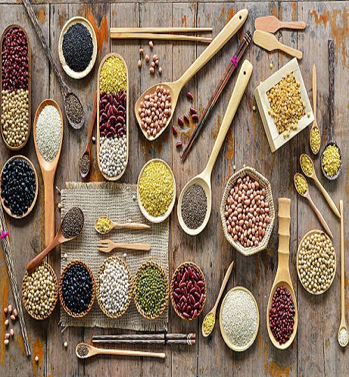 Top view of various leguminous with a wooden cookware