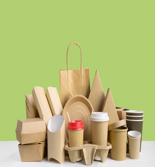 Fast food packaging from eco friendly paper and recycled cardboard isolated on green background. Food containers.