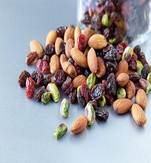 Studio photo of popular "trail mix" snack on new steel countertop. Selective focus in front.