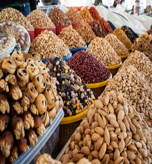 View of colorful sweets and nuts on showcase of local food market, Uzbekistan